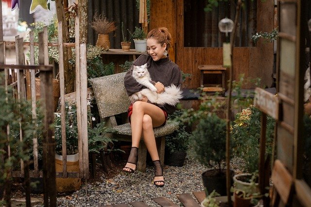 woman hugging her cat